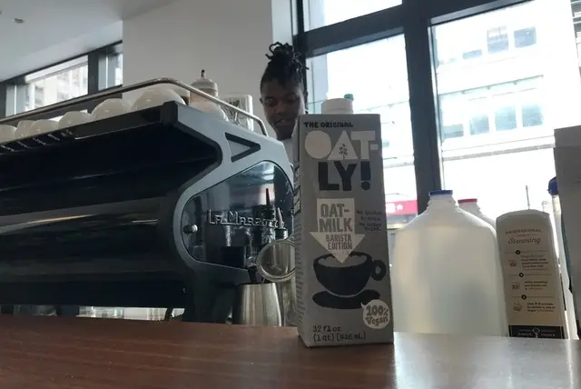 A carton of coveted oat milk on the counter of the Joe's coffee bar inside a Cadillac dealership in Soho
